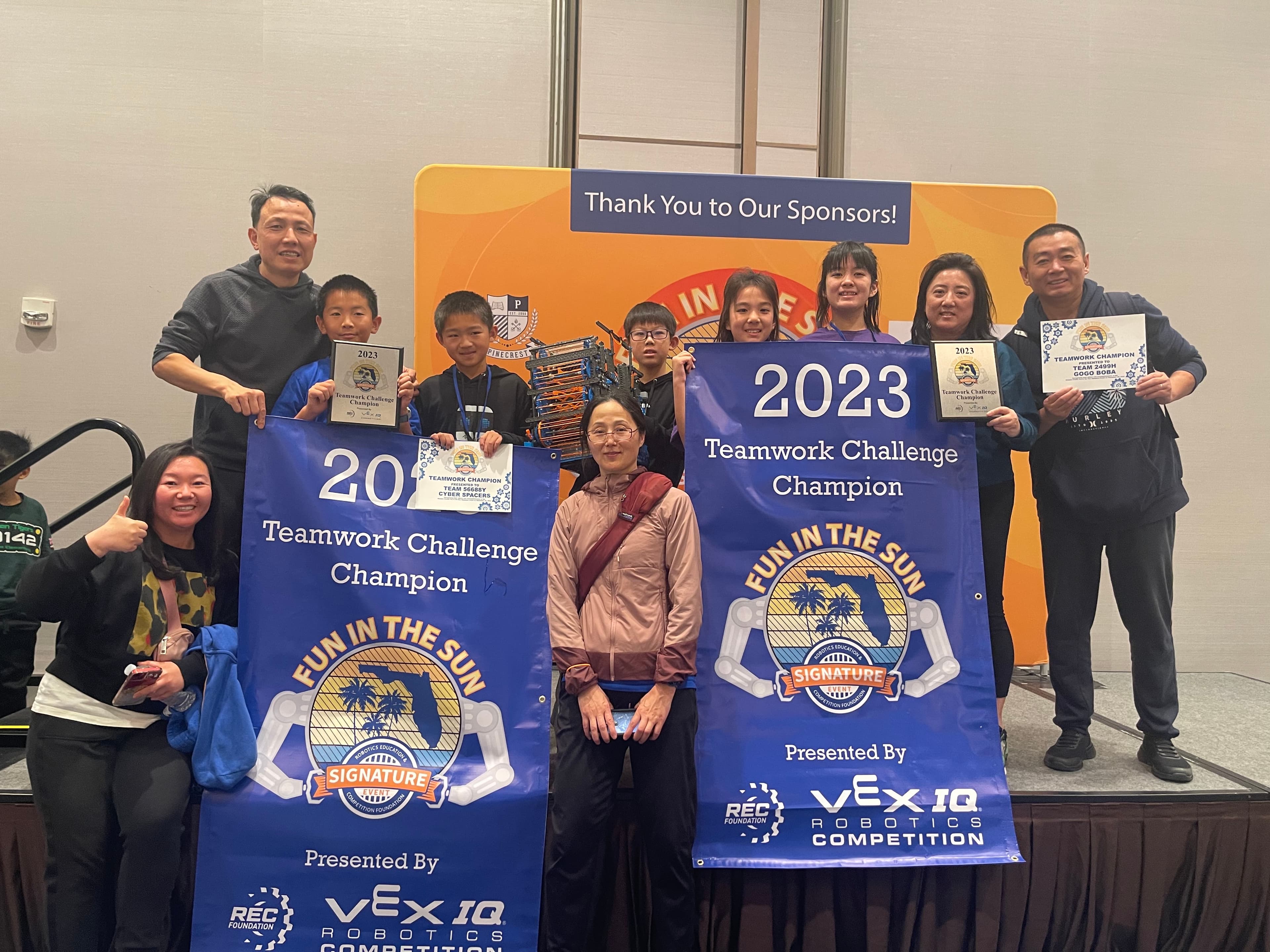 Edubot VEX IQ teams with their Teamwork Challenge Champion banners